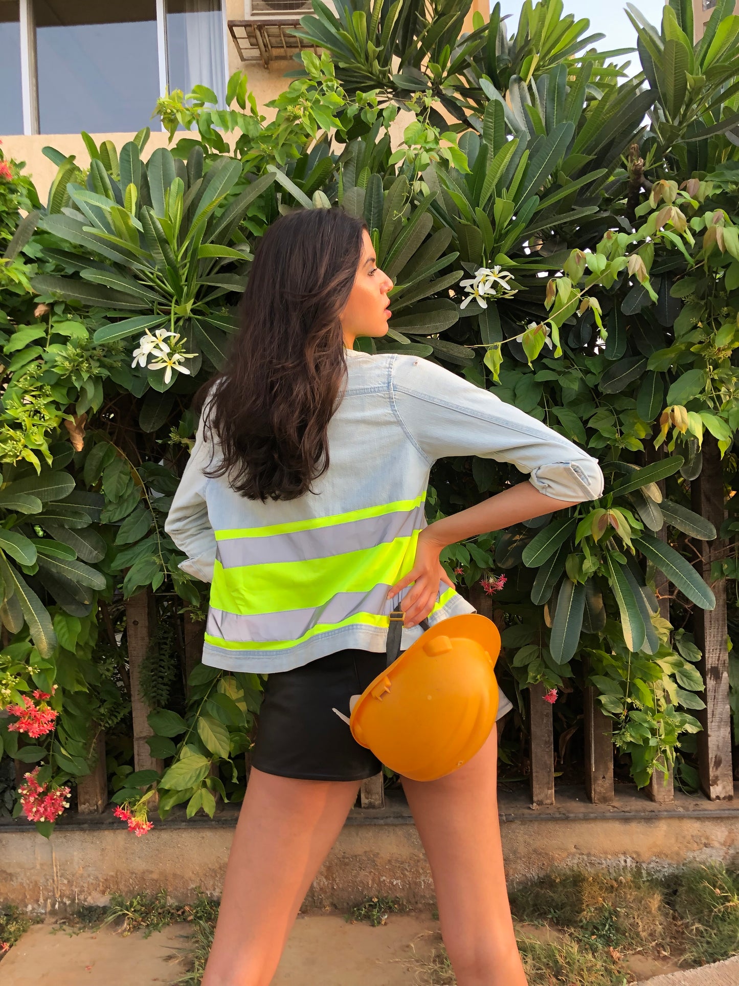 Light blue denim jacket with neon green strap